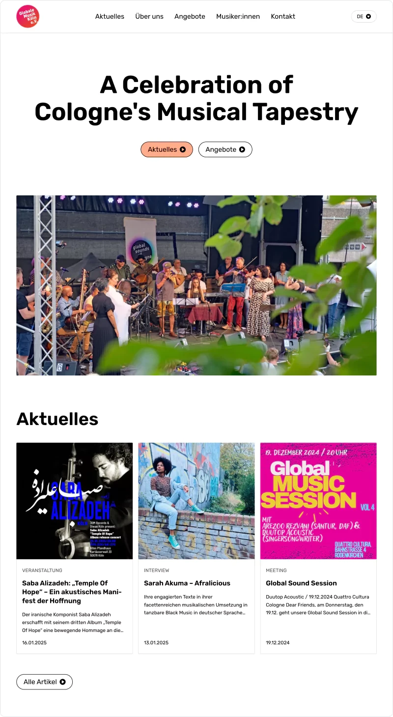 A diverse group of musicians perform on an outdoor stage with lighting and truss, partially obscured by green leaves in the foreground. The scene appears to be part of a musical event celebrating Cologne's musical diversity.